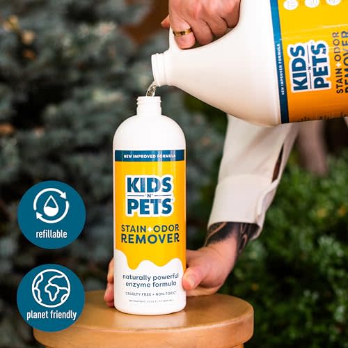 White spray bottle labeled "Kids N Pets Stain Odor Remover" being poured, with blue badges for "refillable" and "planet frien