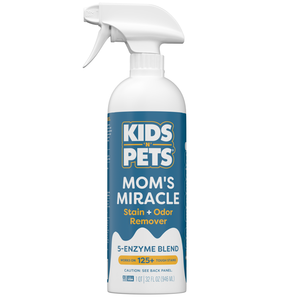 White spray bottle with blue label reading "Kids 'N' Pets Mom's Miracle Stain + Odor Remover, 5-Enzyme Blend, 32 fl oz."