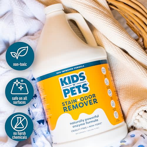 Large white plastic bottle of KidsNPets Stain and Odor Remover with yellow and blue label surrounded by fabric swatches.