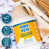 Large white plastic bottle of KidsNPets Stain and Odor Remover with yellow and blue label surrounded by fabric swatches.